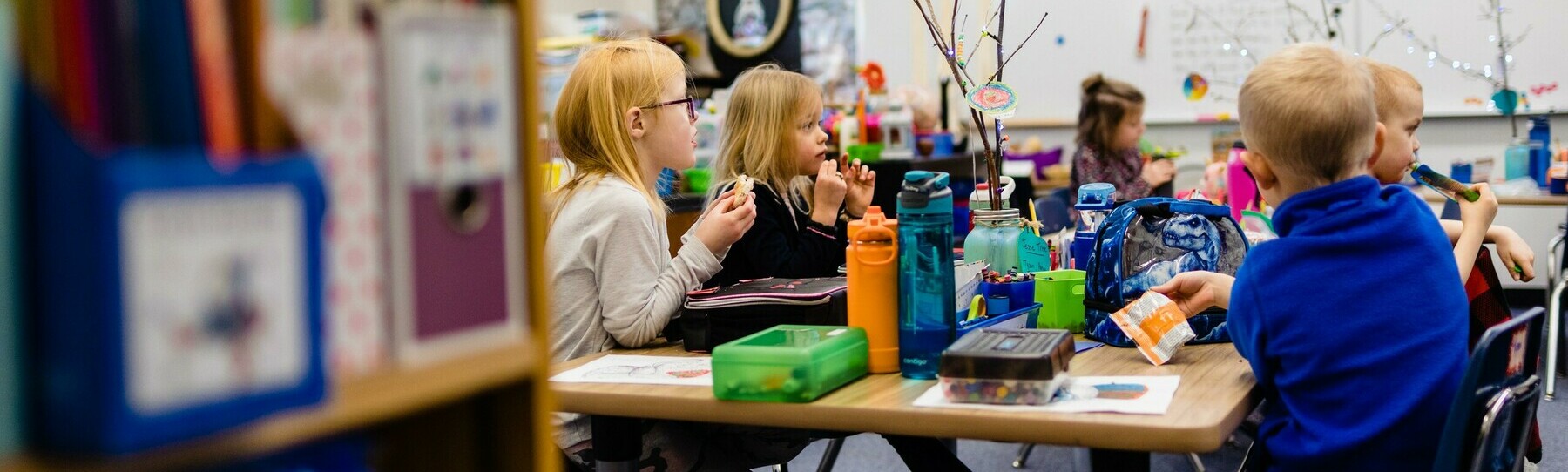 elementary kids at a table in a classroom